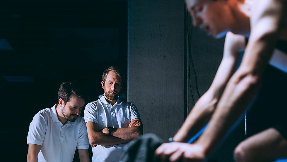 Developer team checks the HPR50 drive unit test of employee on bike