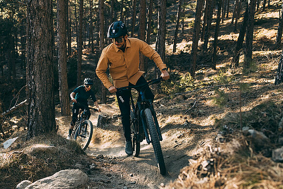 E-bike rider with Trek Fuel EXe ride trail uphill