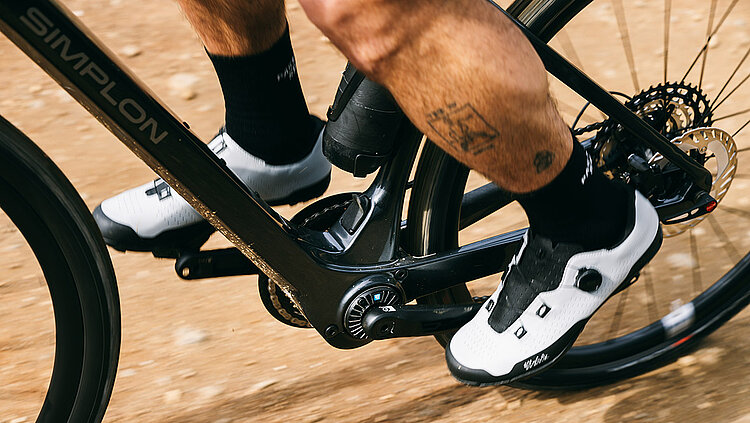 Legs of a gravel bike rider