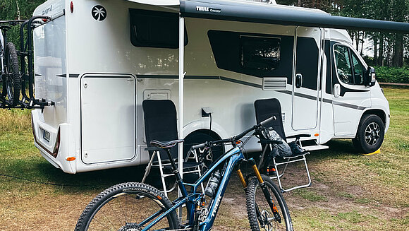 Camper with canopy and e-bike