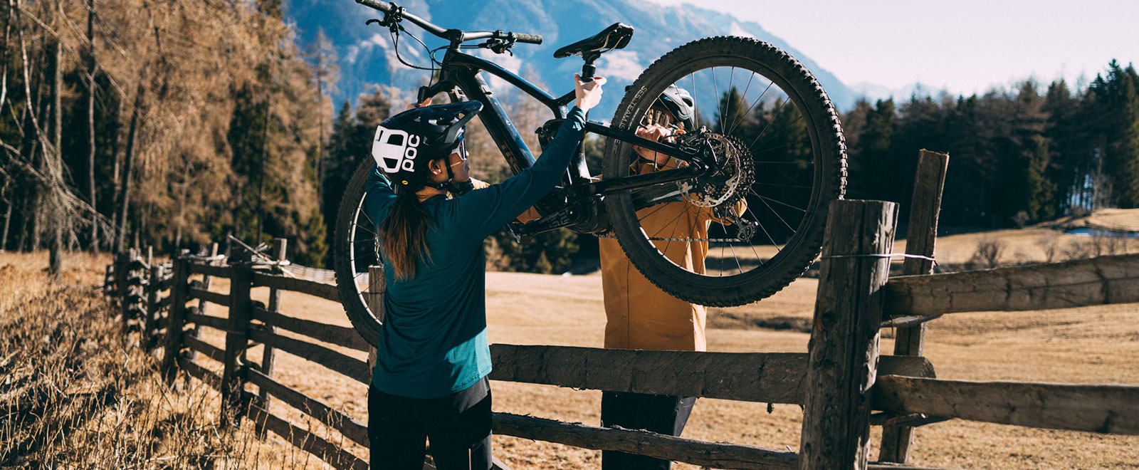 Biker lift e-bike over fence